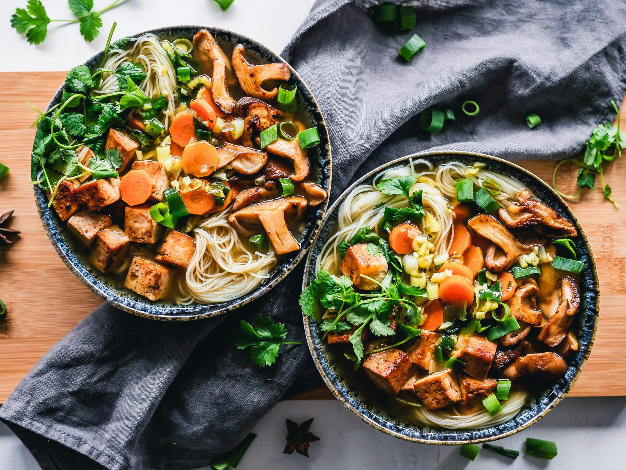 Fresh and colorful chanterelle noodle salad with balsamic vinaigrette dressing in a white serving bowl.