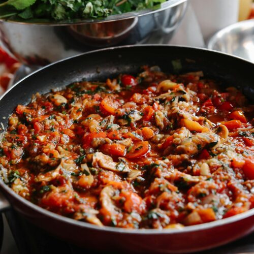 Wild mushroom zaalouk with Moroccan spices served in a bowl, garnished with fresh cilantro.